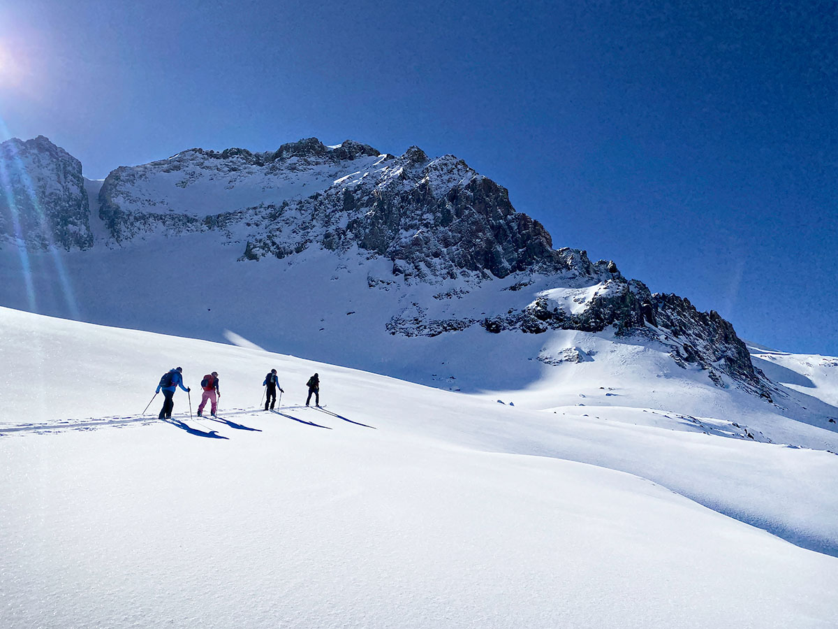 skiers touring up mountain