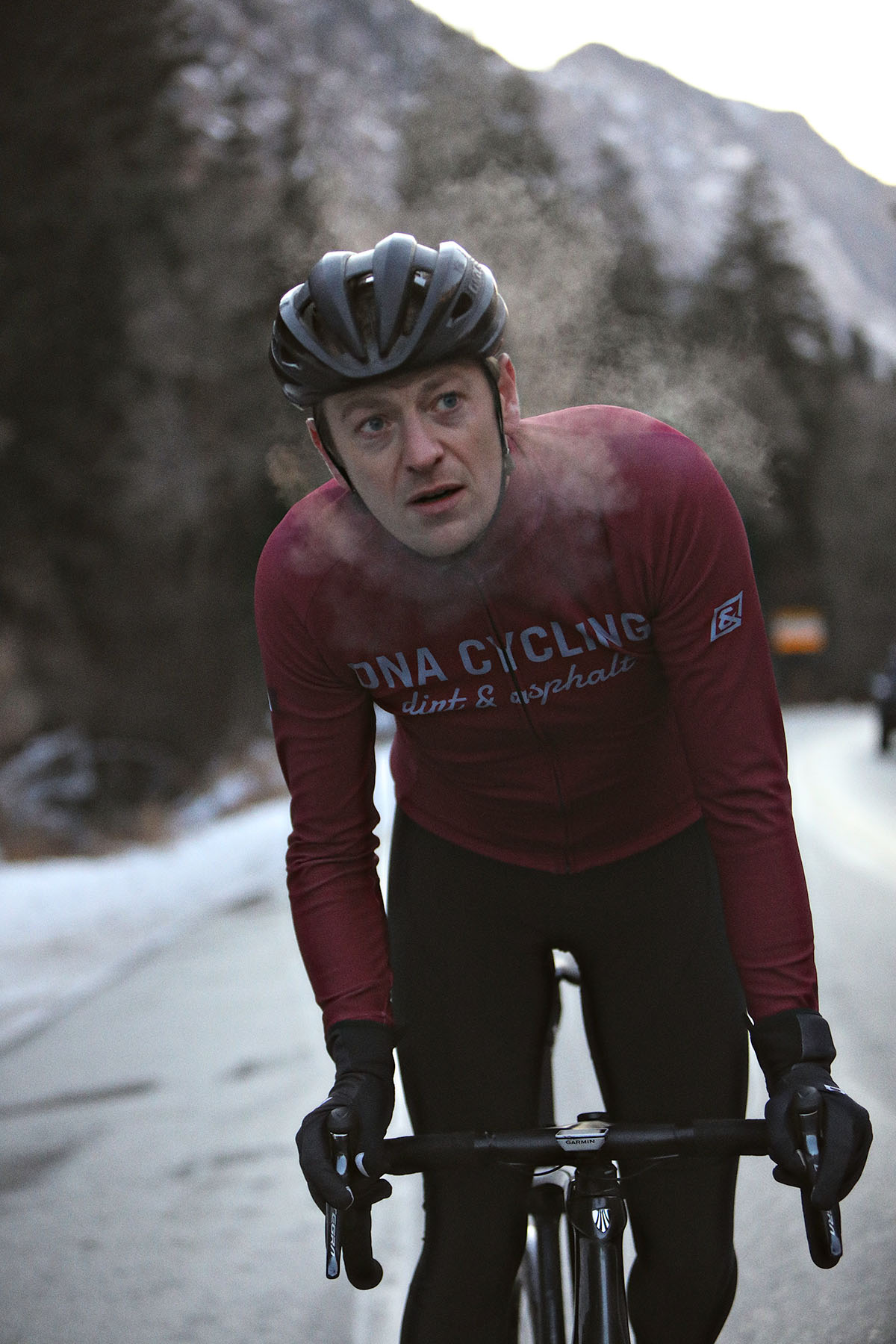 person biking in winter wearing dna cycling outerwear