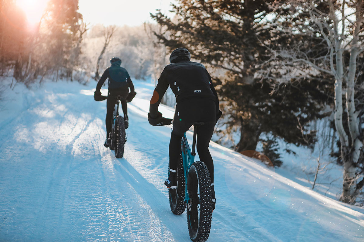 two bikers fat biking in the snow wearing dna cycling kits