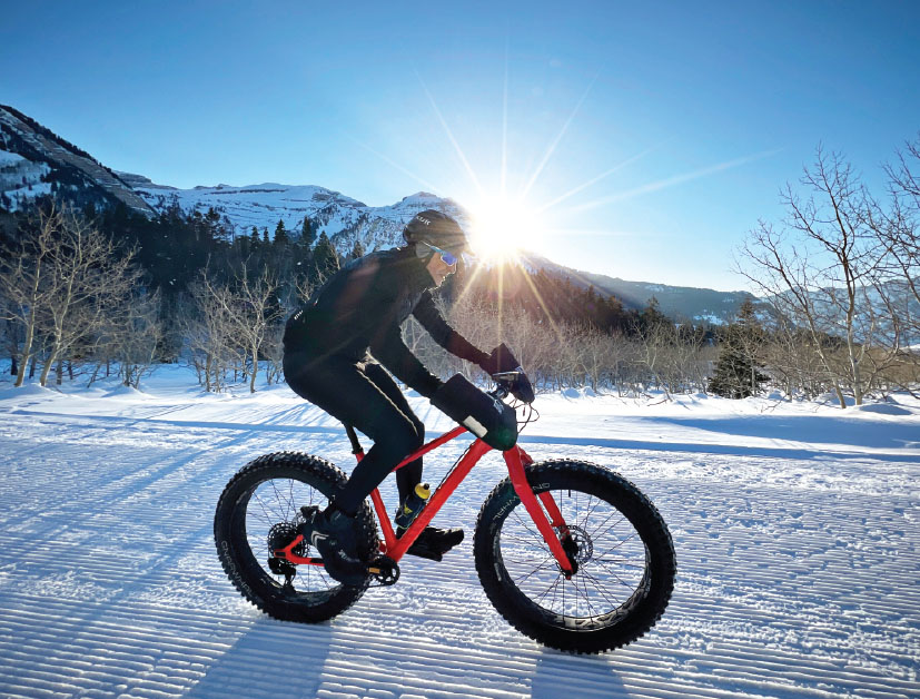 person fat biking on red bike