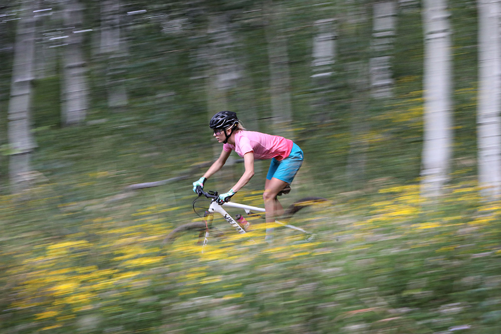 women riding mountain bike in dna cycling gear.