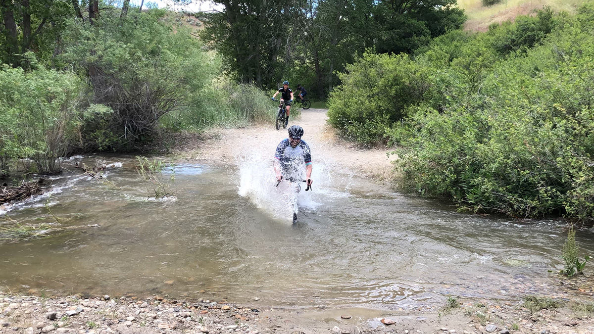 person riding bike through water