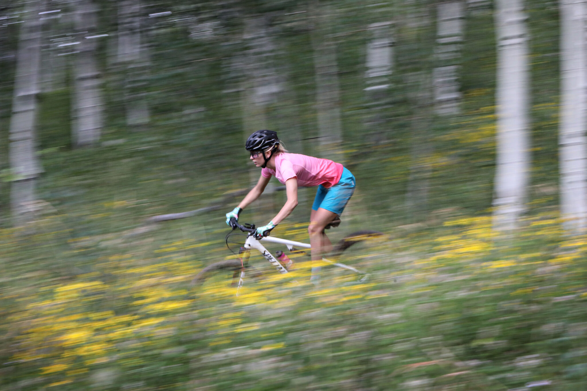 image of women riding bike in DNA cycling jersey
