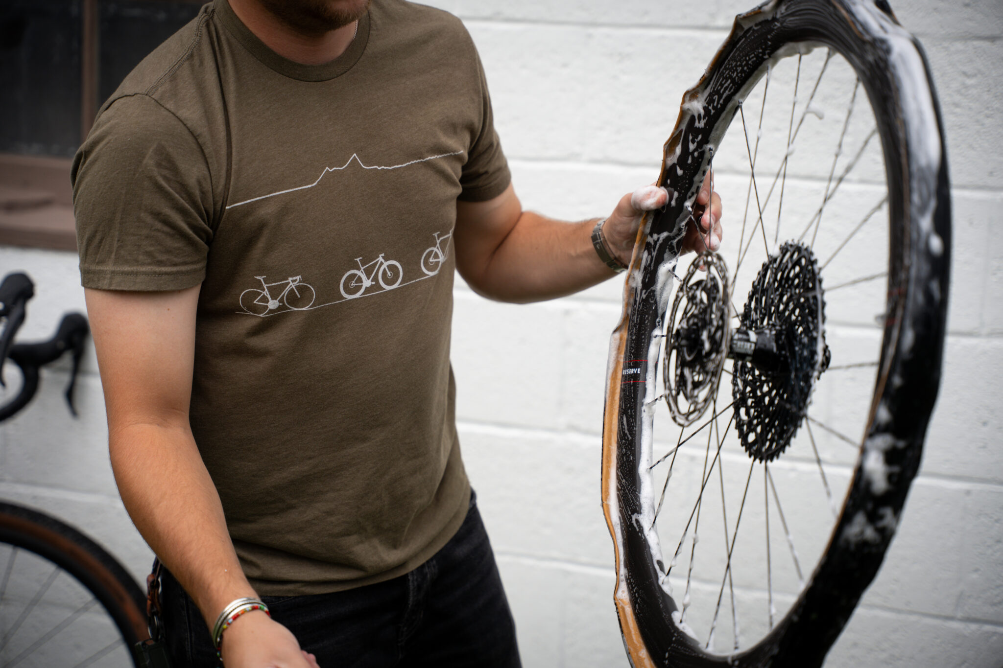 person cleaning bike wheel