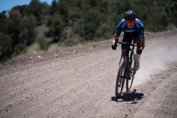 alex wilde riding gravel road in dna kit